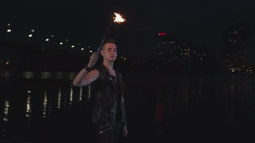 Fireshow Artist Breathing Fire By City Riverside
