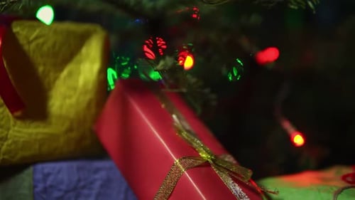 Christmas Gifts Under Tree with Colorful Lights
