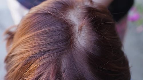 Close Up of Parted Aubrun Woman's Hair