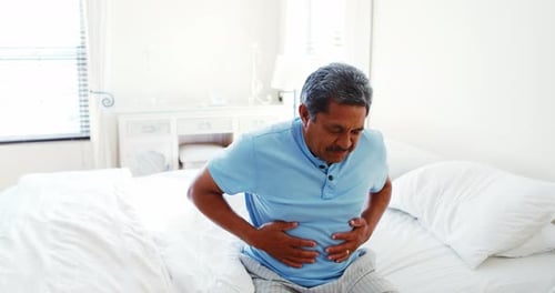 Upset senior man suffering from stomachache 4k