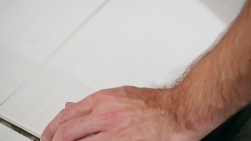 Installing Light-Colored Tile with Gray Adhesive Indoors