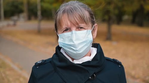 Adult Woman Wearing Mask Outdoors in Autumn