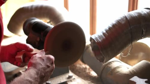 Woodworker Shaping Wood on Lathe in Workshop