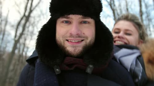 Woman Hugging His Close Up in Snowcovered Forest