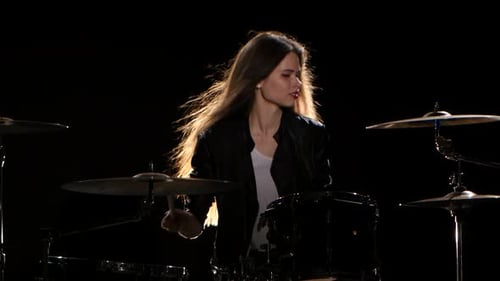 Woman Plays Drums in Black Leather Jacket