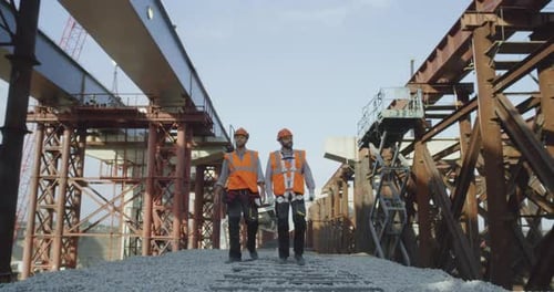 Builders Walking Near Unfinished Bridge