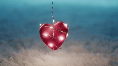 Red Heart with Glowing Lights Hanging in Dreamy Setting