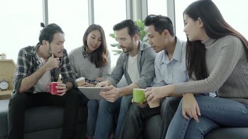 Colleagues Meeting Using Tablet Device in Office