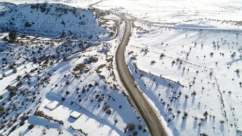 Asphalt road, snowy land.