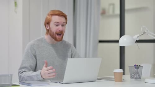 Man Excited by Video Call on Laptop