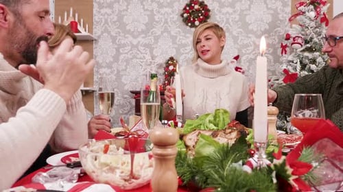 Adults Toasting Champagne at Christmas Dinner Table