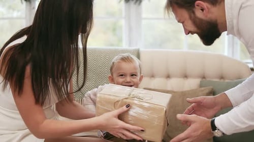 Family Giving Present in Bright Home