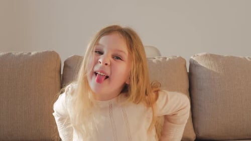 Cheeky little girl. Cute little girl grimacing