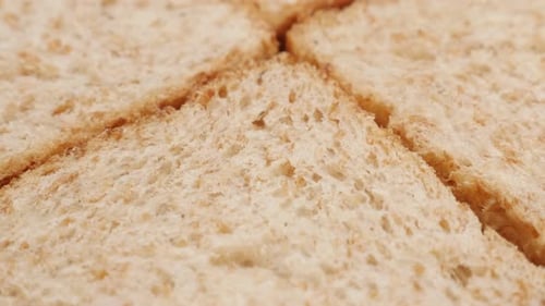 Tilting on four pieces complete bread made of full grain close-up 4K 2160p 30fps UltraHD footage -