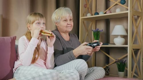 Grandmother and Child Play Video Games Indoors
