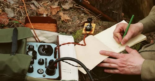 Vintage Radio Operator Taking Notes in Forest