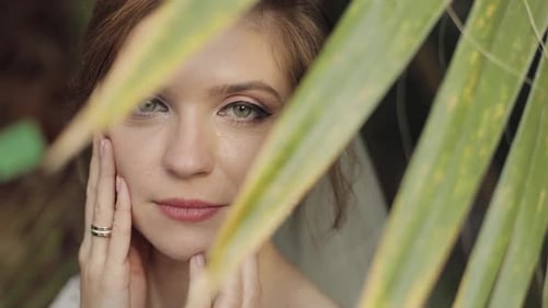 Face of Beautiful and Lovely Bride in Wedding Dress in the Park. Slow Motion