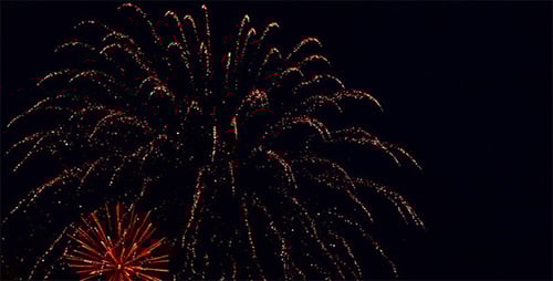 Dramatic Fireworks Exploding Against Night Sky Background