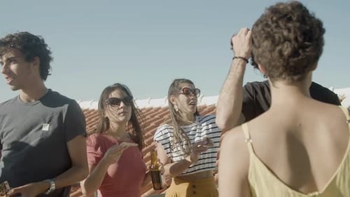Women Looking for Friend with Eyes During Rooftop Party
