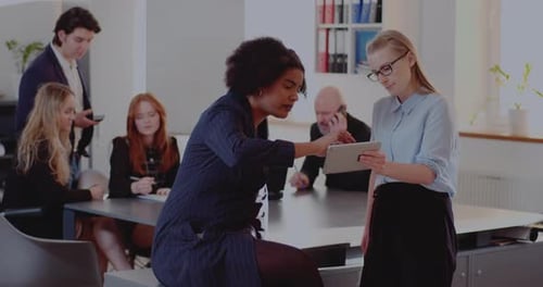 Business Team Collaborating on Tablet in Modern Office