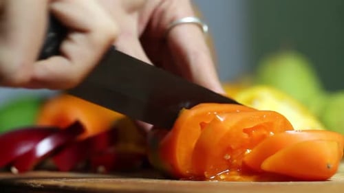 Tomato Slicing with Sharp Knife in Close Up