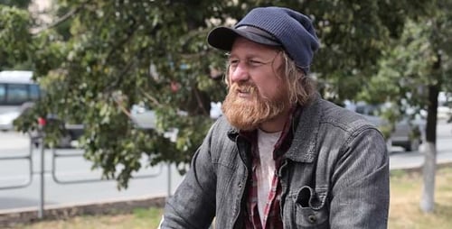 Man with Red Beard Outside in an Urban Park