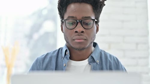 Young Adult Concentrates While Working