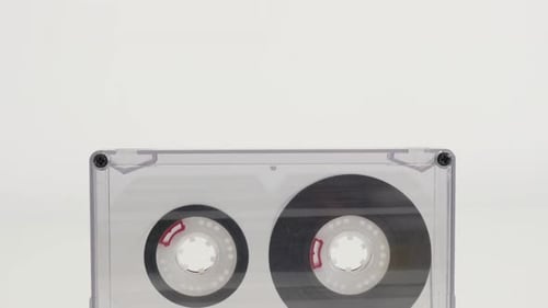 Clear Cassette Tape Rotating on White Background