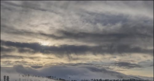 Sun Rising Over Misty Mountain Range