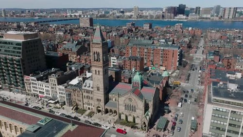 Aerial Descending Footage of Old Stone Church in Town Development