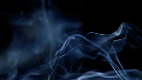 White Smoke Swirls Against Black Background