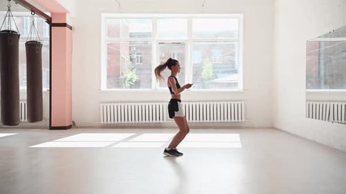 Cute Young Girl Jumping Rope in Gym Warm Up Before Training
