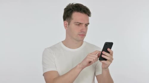 Excited Man Celebrates Success on Smartphone