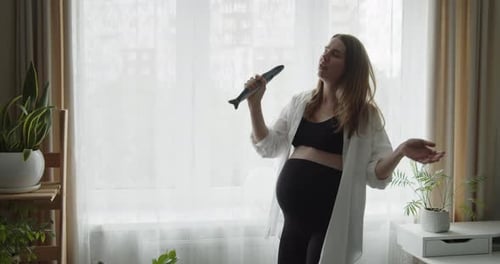 Pregnant Woman Expressively Singing with Toy at Home