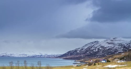 Cloud rolling time lapse over snow mountain fjords in Akureyri, Iceland.