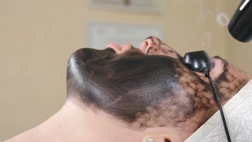 Woman Receiving a Skincare Treatment with Steam