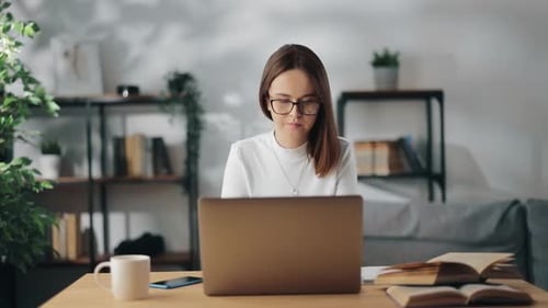 Woman Works at Laptop from Home Office