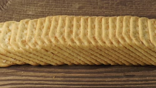 Crisp Crackers Neatly Stacked on Rustic Wood Surface