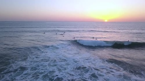 Why do all surfers always meet in the water at sunset? Fantastic aerial view flight pull in drone fo