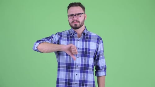 Young Man Giving Thumbs Down on Green Screen