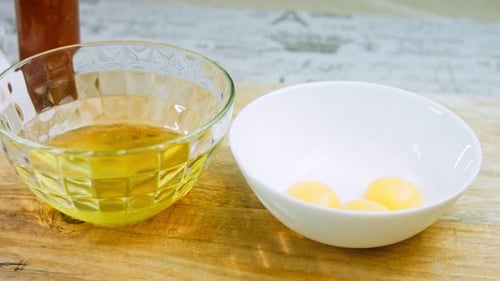 Egg Yolks and Whites in Bowls for Cooking