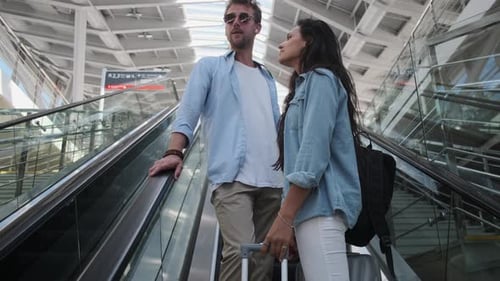Train Passengers with Luggage on Escalator at the Station
