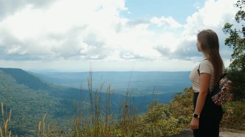 Adventurous Female Tourist on Rock