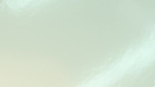 Peach Dropping into Milky Liquid with Ripples