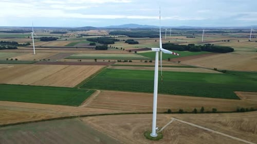 Windmill Turbine in the Field at Summer Day