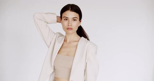 Stylish Woman Posing with Blazer in Studio