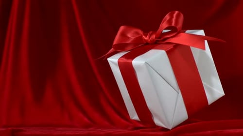 Present falls onto red fabric, Slow Motion