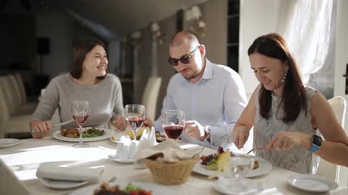The Company of Friends or Work Colleagues Having Lunch in the Restaurant