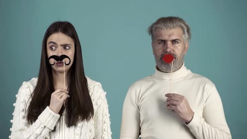 Woman and Man Making Faces with Photo Props