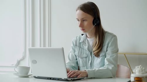 Woman Working at Computer with Headset
